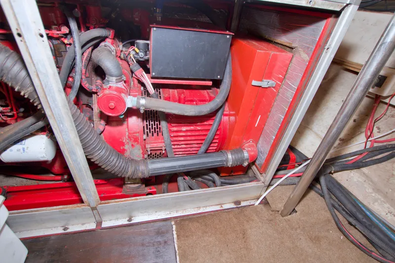 Slide: The Image of Engine room of a 1994 Jefferson Marquessa 56 Extended Deckhouse yacht, featuring red machinery. - 123