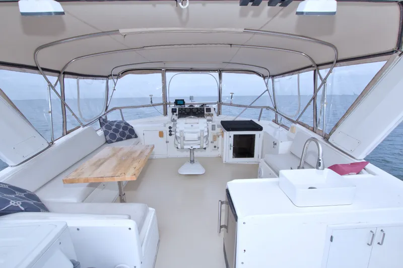 Slide: The Image of Spacious interior of 1994 Jefferson Marquessa 56 yacht with seating, table, and helm. - 16