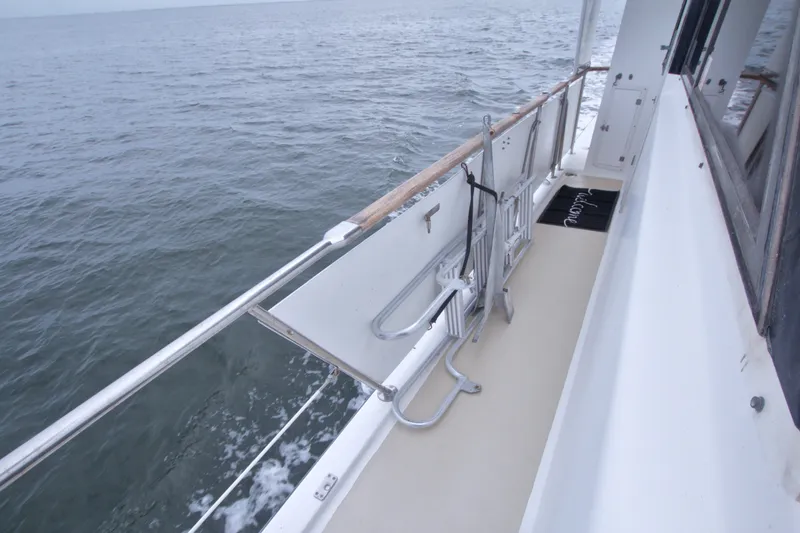 Slide: The Image of Side deck of 1994 Jefferson Marquessa 56 yacht cruising on open water. - 49