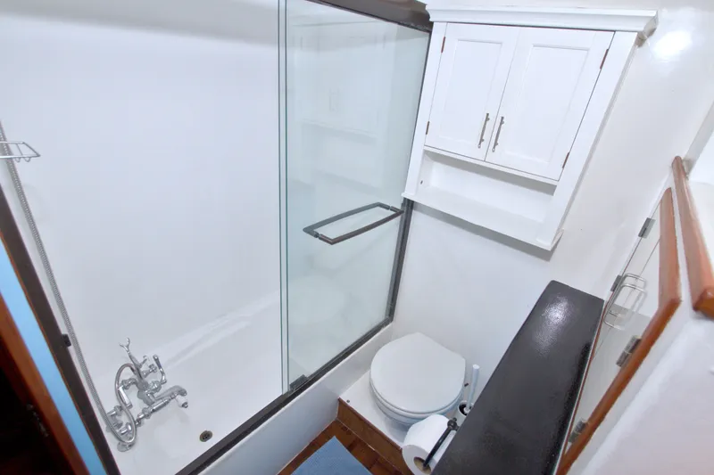 Slide: The Image of Bathroom interior of 1994 Jefferson Marquessa 56 yacht, featuring shower, toilet, and storage cabinet. - 95