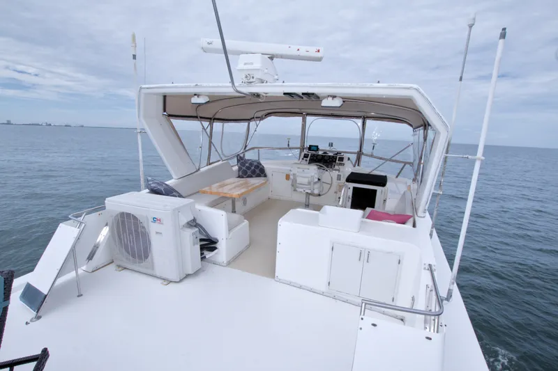 Slide: The Image of 1994 Jefferson Marquessa 56 yacht deckhouse with seating, ocean view, and navigation equipment. - 15
