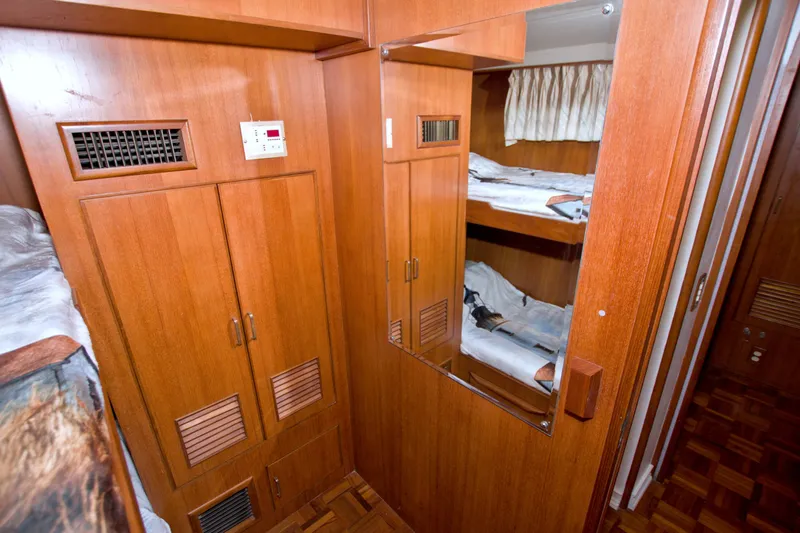 Slide: The Image of Interior of 1994 Jefferson Marquessa 56 yacht with wooden cabinetry and bunk beds. - 73