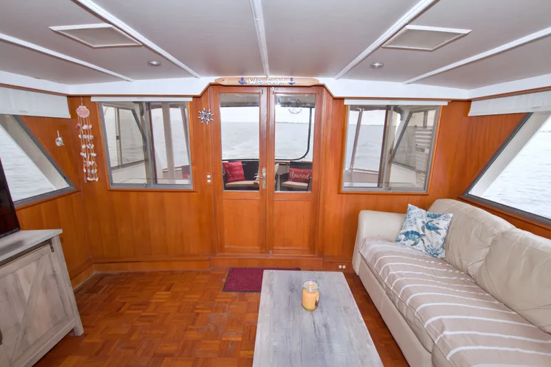 Slide: The Image of Interior of 1994 Jefferson Marquessa 56 yacht with wood paneling and comfortable seating. - 29