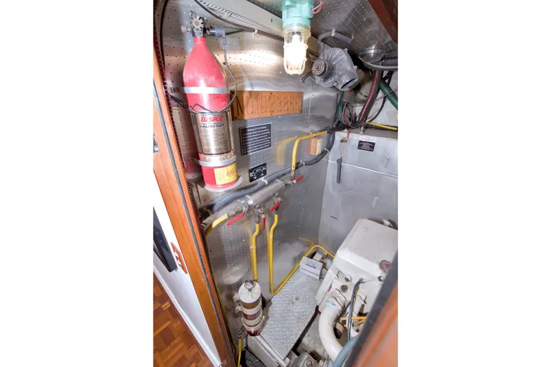 Slide: The Image of Engine room of 1994 Jefferson Marquessa 56 yacht with fire extinguisher and wiring. - 111