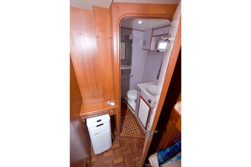 Slide: The Image of Bathroom interior of 1994 Jefferson Marquessa 56 Extended Deckhouse yacht, featuring wood accents. - 75