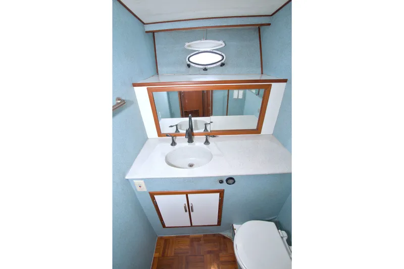 Slide: The Image of Bathroom interior of 1994 Jefferson Marquessa 56 yacht, featuring sink, mirror, and toilet. - 67
