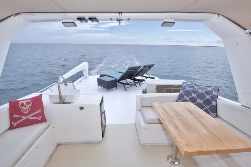Slide: The Image of 1994 Jefferson Marquessa 56 yacht deck with seating, table, and ocean view. - 19