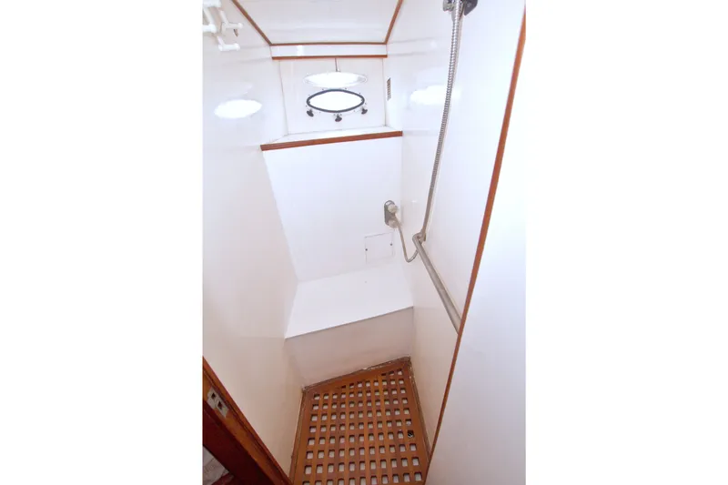 Slide: The Image of Shower area in 1994 Jefferson Marquessa 56 Extended Deckhouse yacht, featuring wooden floor grating. - 69