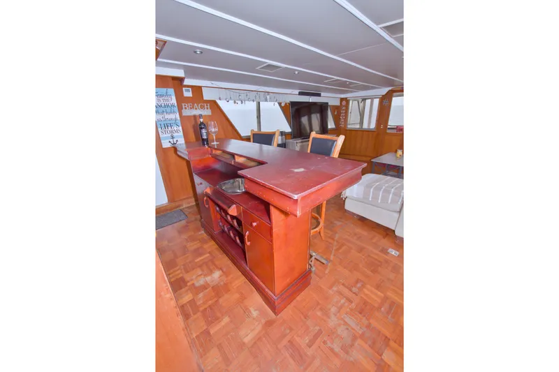 Slide: The Image of Interior of 1994 Jefferson Marquessa 56 yacht with wooden bar and seating area. - 38