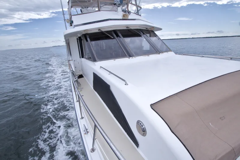 Slide: The Image of 1994 Jefferson Marquessa 56 yacht cruising on open water under a clear sky. - 48