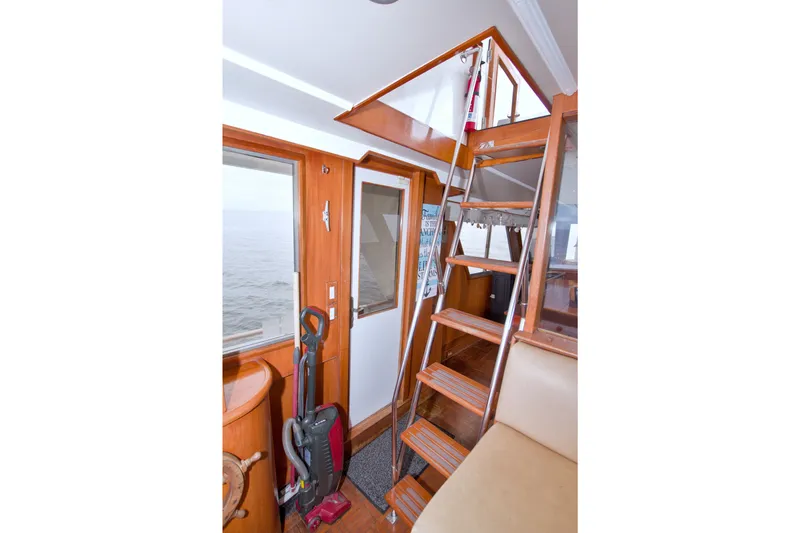 Slide: The Image of Interior of 1994 Jefferson Marquessa 56 yacht with wooden stairs and ocean view. - 24