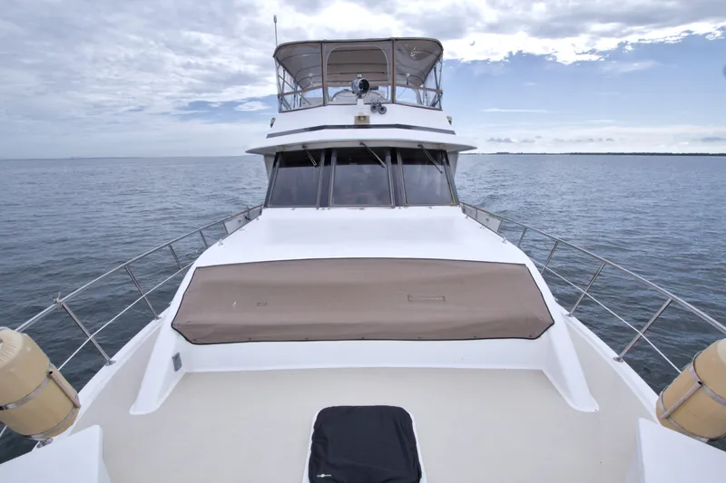 Slide: The Image of 1994 Jefferson Marquessa 56 yacht on open water, showcasing deck and helm. - 47