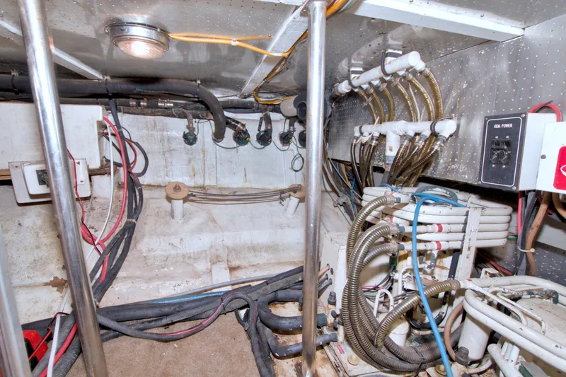 Slide: The Image of Engine room of a 1994 Jefferson Marquessa 56 Extended Deckhouse with wiring and pipes. - 125