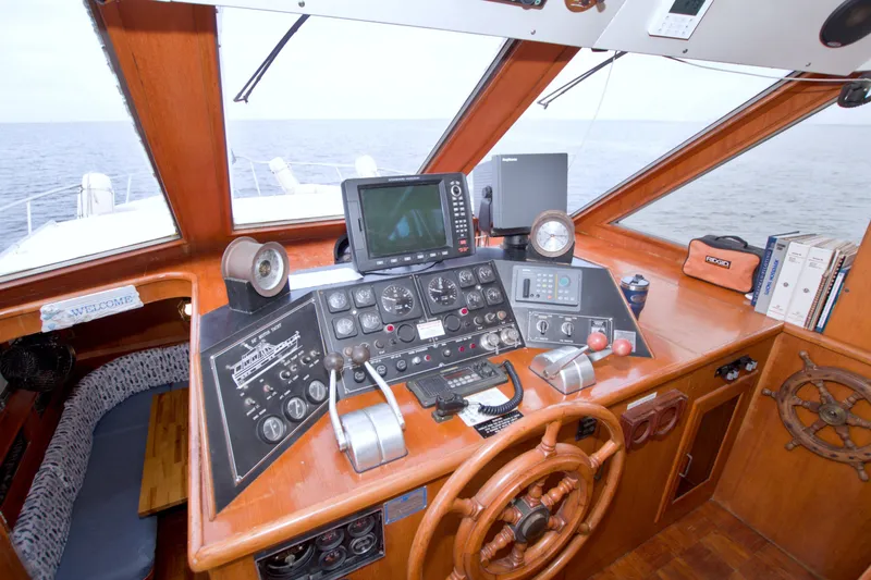 Slide: The Image of Cockpit of 1994 Jefferson Marquessa 56 yacht with navigation instruments and wooden steering wheel. - 54
