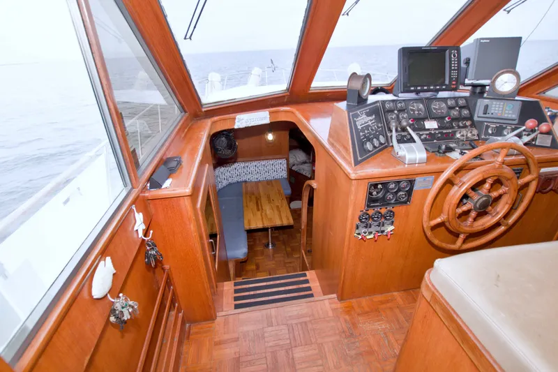 Slide: The Image of Interior of 1994 Jefferson Marquessa 56 yacht with wooden helm and navigation equipment. - 56