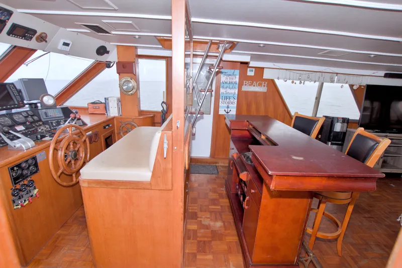 Slide: The Image of Interior of 1994 Jefferson Marquessa 56 yacht with helm, bar, and seating area. - 37