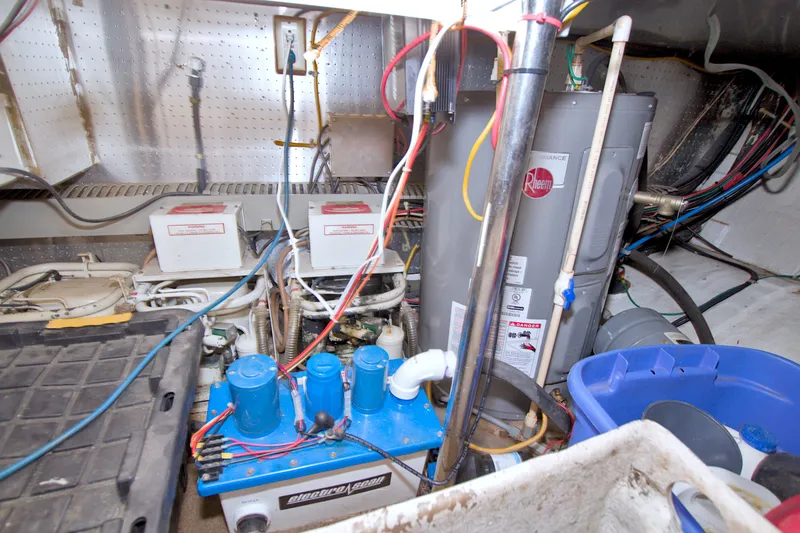 Slide: The Image of Engine room of 1994 Jefferson Marquessa 56 yacht with water heater and electrical components. - 128