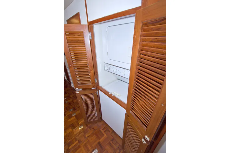 Slide: The Image of Laundry area with wooden louvered doors on a 1994 Jefferson Marquessa 56 yacht. - 83