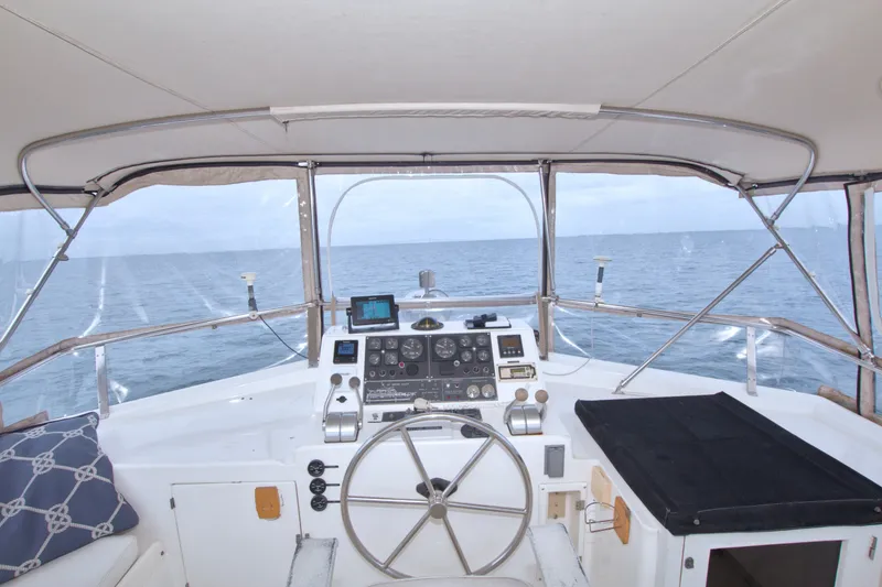 Slide: The Image of Cockpit view of 1994 Jefferson Marquessa 56 Extended Deckhouse yacht on open sea. - 21