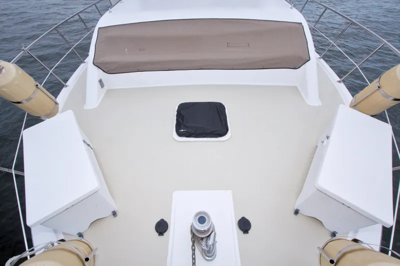 Slide: The Image of 1994 Jefferson Marquessa 56 Extended Deckhouse yacht deck with railing and covered hatch. - 46
