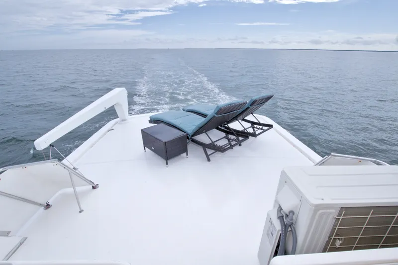 Slide: The Image of Deck of 1994 Jefferson Marquessa 56 yacht with lounge chairs and ocean view. - 12