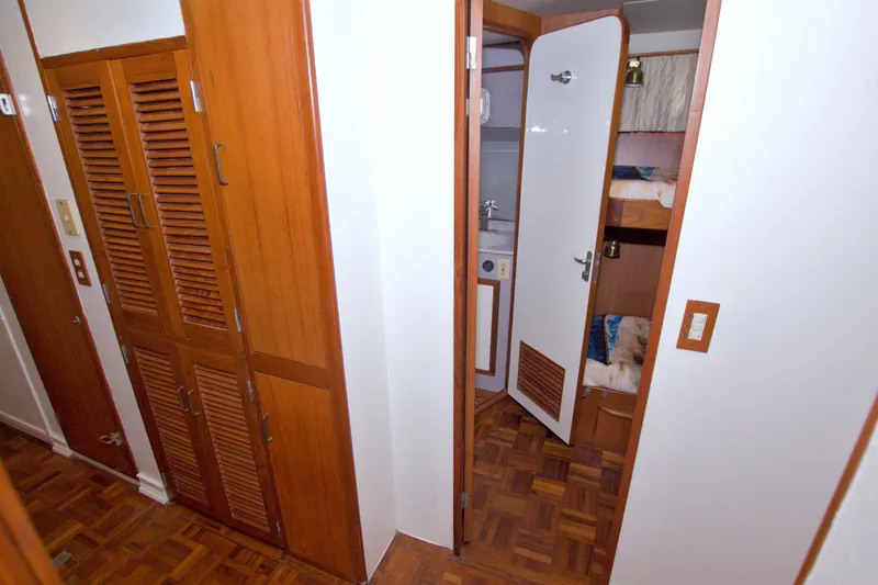 Slide: The Image of Interior of 1994 Jefferson Marquessa 56 yacht with wooden cabinets and open door to cabin. - 82