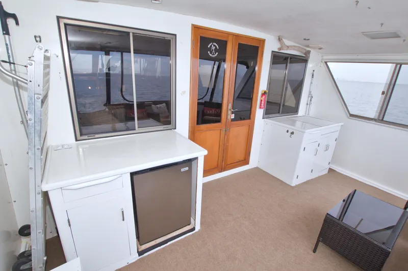 Slide: The Image of 1994 Jefferson Marquessa 56 yacht interior with windows, cabinets, and ocean view. - 33
