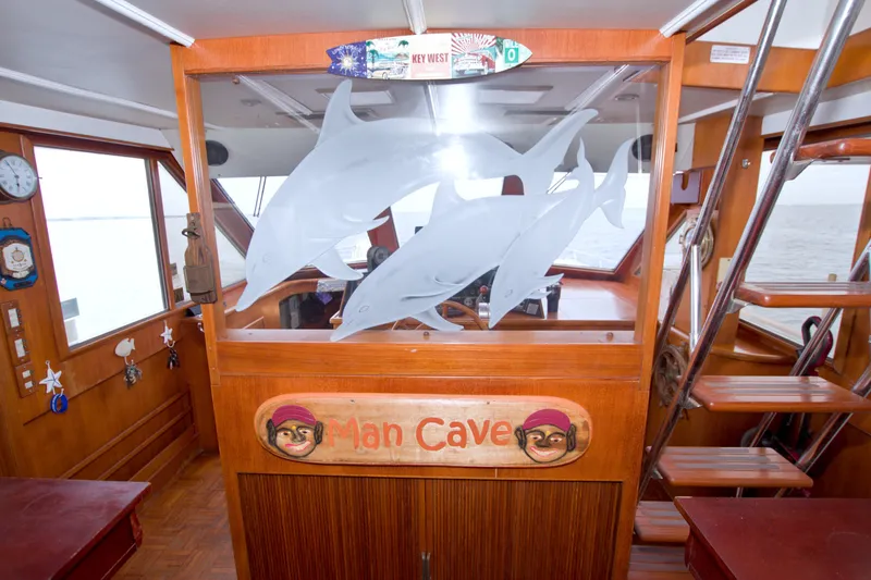 Slide: The Image of Interior of 1994 Jefferson Marquessa 56 yacht with dolphin decor and "Man Cave" sign. - 39