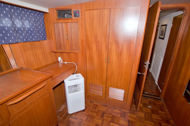 Slide: The Image of 1994 Jefferson Marquessa 56 yacht interior with wooden cabinetry and portable air conditioner. - 89