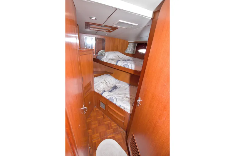 Slide: The Image of Interior of 1994 Jefferson Marquessa 56 yacht with wooden bunk beds and cozy decor. - 62