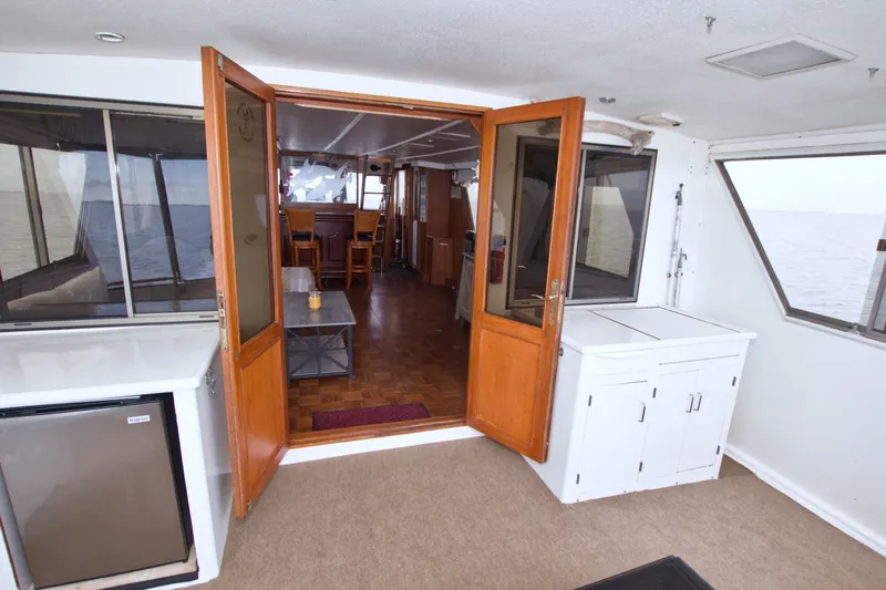 Slide: The Image of Interior view of 1994 Jefferson Marquessa 56 yacht with wooden doors and seating area. - 34