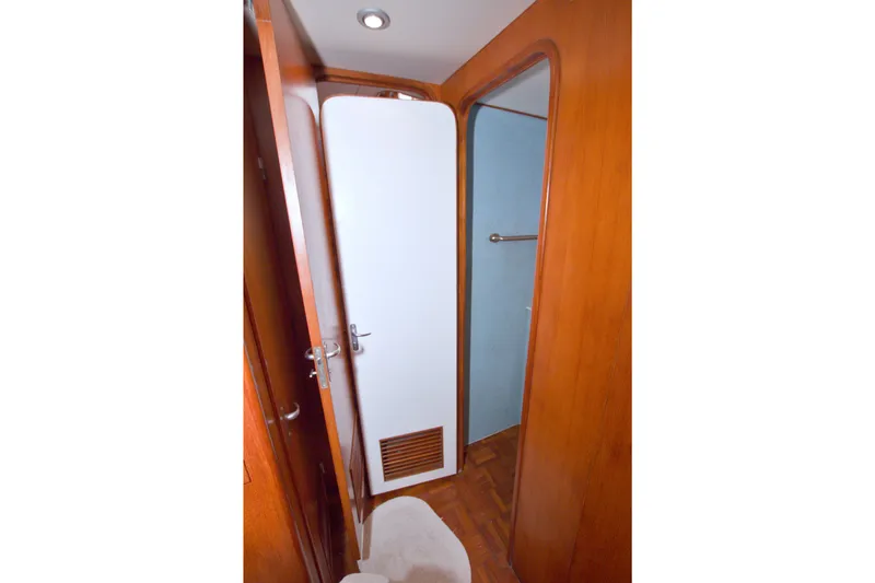 Slide: The Image of Interior view of 1994 Jefferson Marquessa 56 yacht, featuring wooden doors and a compact hallway. - 65
