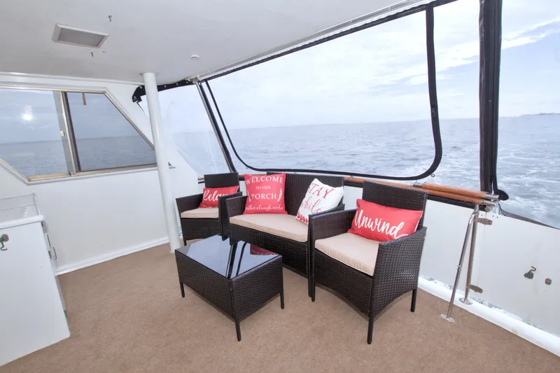 Slide: The Image of 1994 Jefferson Marquessa 56 yacht deck with wicker seating and ocean view. - 32