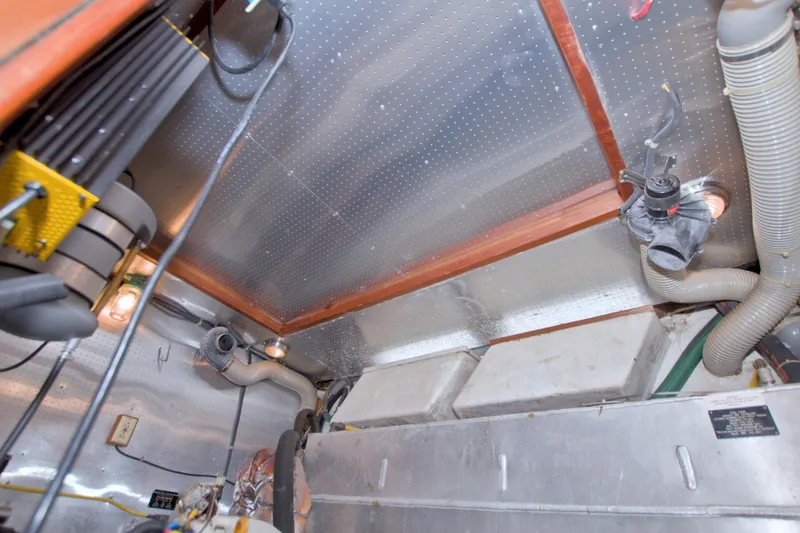 Slide: The Image of Engine room of 1994 Jefferson Marquessa 56 Extended Deckhouse yacht, featuring pipes and equipment. - 104