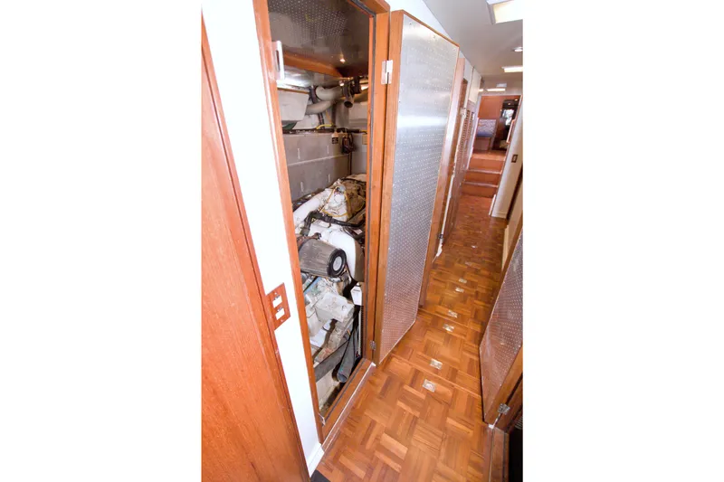 Slide: The Image of Engine room of 1994 Jefferson Marquessa 56 yacht with wooden flooring and metallic doors. - 98