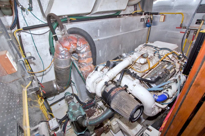 Slide: The Image of Engine room of a 1994 Jefferson Marquessa 56 Extended Deckhouse yacht, showcasing mechanical components. - 102
