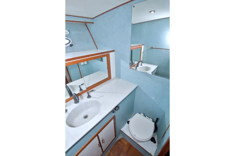 Slide: The Image of Bathroom interior of 1994 Jefferson Marquessa 56 yacht, featuring sink, mirror, and toilet. - 66