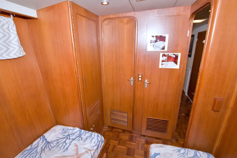 Slide: The Image of Interior of 1994 Jefferson Marquessa 56 yacht with wooden paneling and cozy cabin decor. - 79