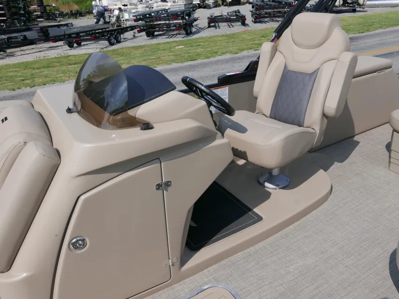 Slide: The Image of 2024 Starcraft SLS 3 Q DH boat helm with beige seating and steering console. - 11