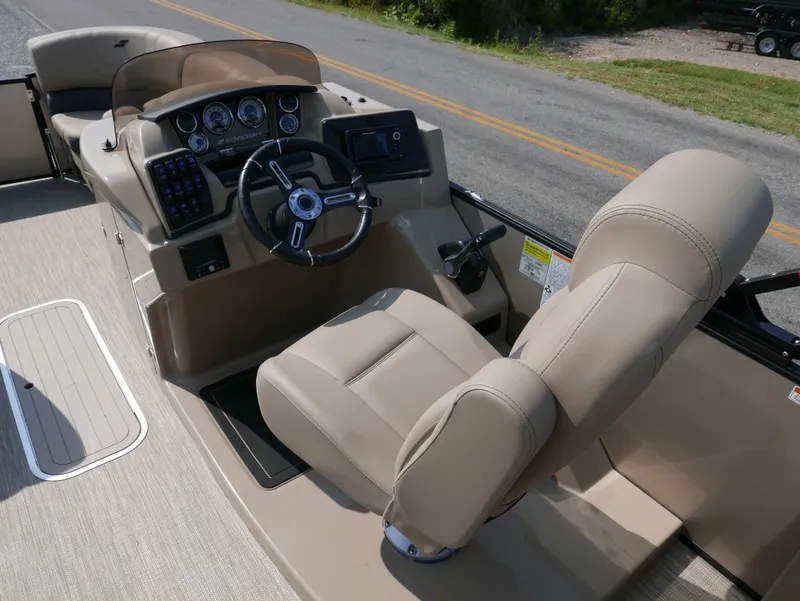 Slide: The Image of 2024 Starcraft SLS 3 Q DH boat interior with beige captain's chair and control panel. - 12
