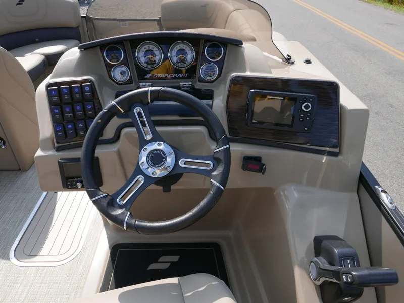Slide: The Image of 2024 Starcraft SLS 3 Q DH boat dashboard with steering wheel and control panel. - 13