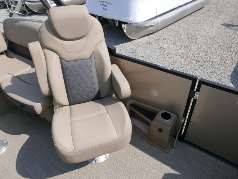 Slide: The Image of 2024 Starcraft SLS 3 Q DH boat interior with beige seating and cup holder. - 17