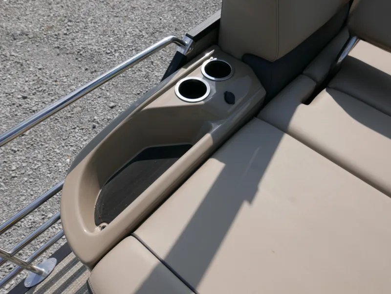 Slide: The Image of 2024 Starcraft SLS 3 Q DH boat interior with beige seating and dual cup holders. - 23