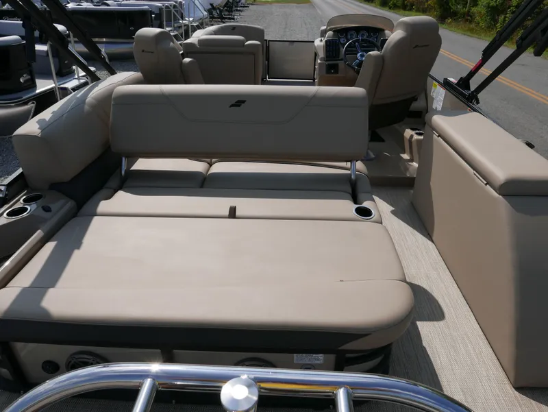 Slide: The Image of 2024 Starcraft SLS 3 Q DH boat interior with beige seating and modern dashboard. - 24