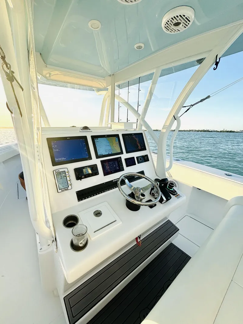 Slide: The Image of 2023 SeaHunter 33 boat helm with advanced navigation systems and ocean view. - 4