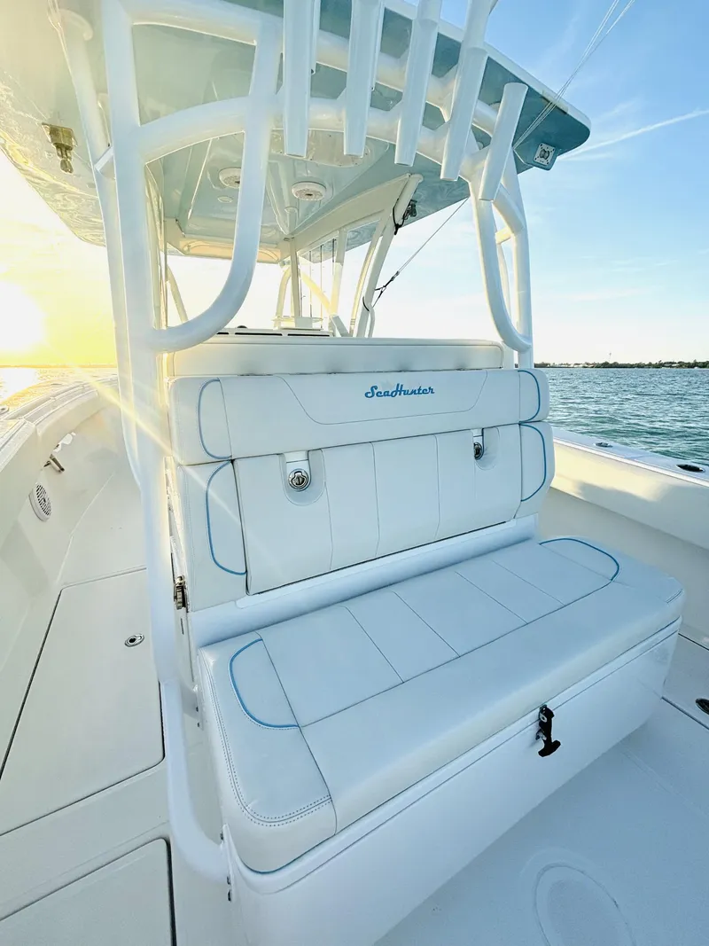 Slide: The Image of 2023 SeaHunter 33 boat with white seating and ocean backdrop. - 5