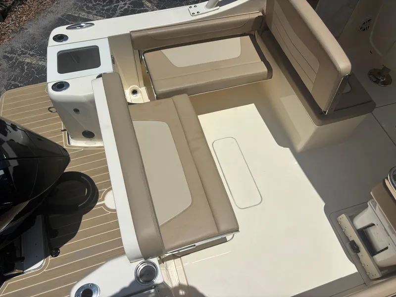 Slide: The Image of 2024 Scout 240 Dorado boat interior with beige seating and deck layout. - 10