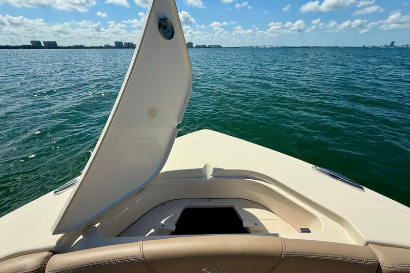 Slide: The Image of 2024 Scout 240 Dorado boat on water, open hatch, sunny day, scenic view. - 19