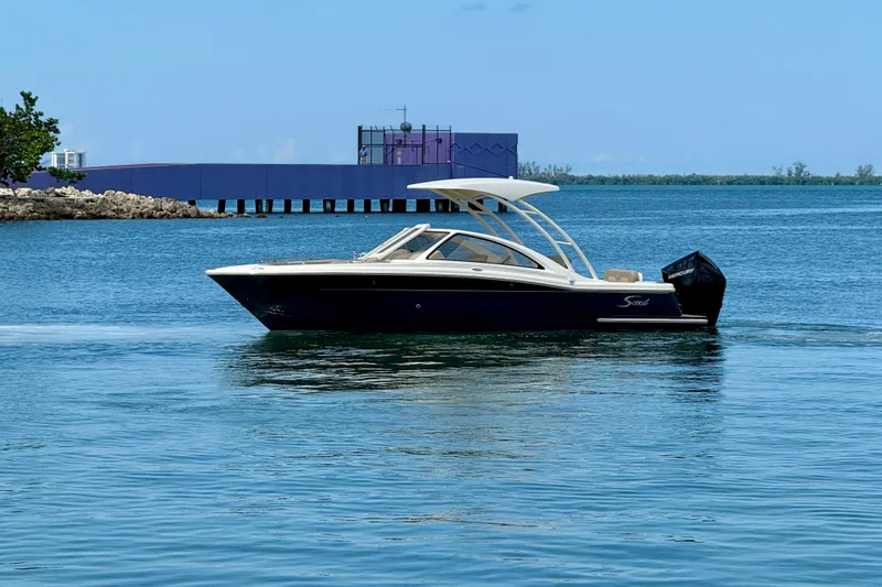 Slide: The Image of 2024 Scout 240 Dorado boat cruising on calm blue waters. - 2
