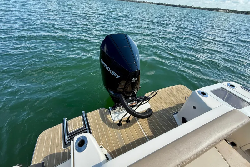 Slide: The Image of 2024 Scout 240 Dorado boat with Mercury outboard motor on water. - 7
